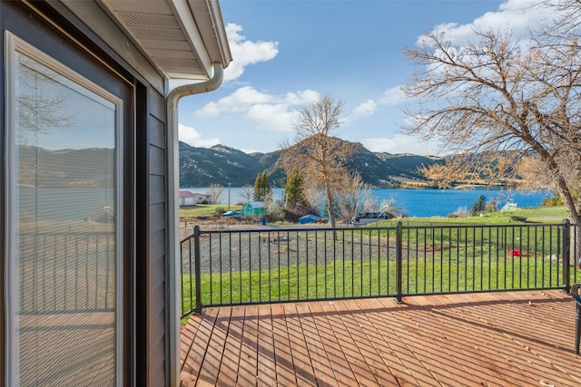 balcony featuring a water and mountain view