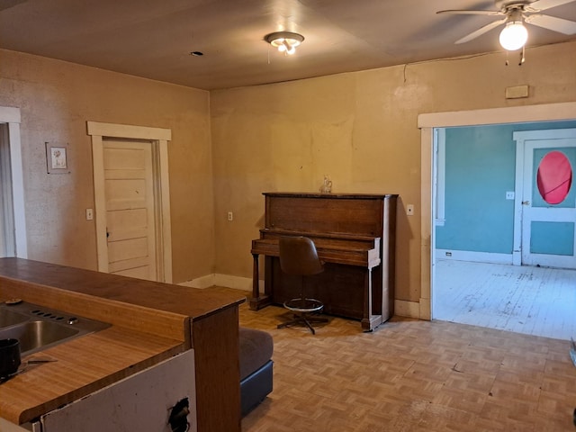 misc room with ceiling fan and light parquet floors