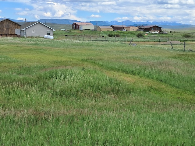 view of yard with a mountain view and a rural view