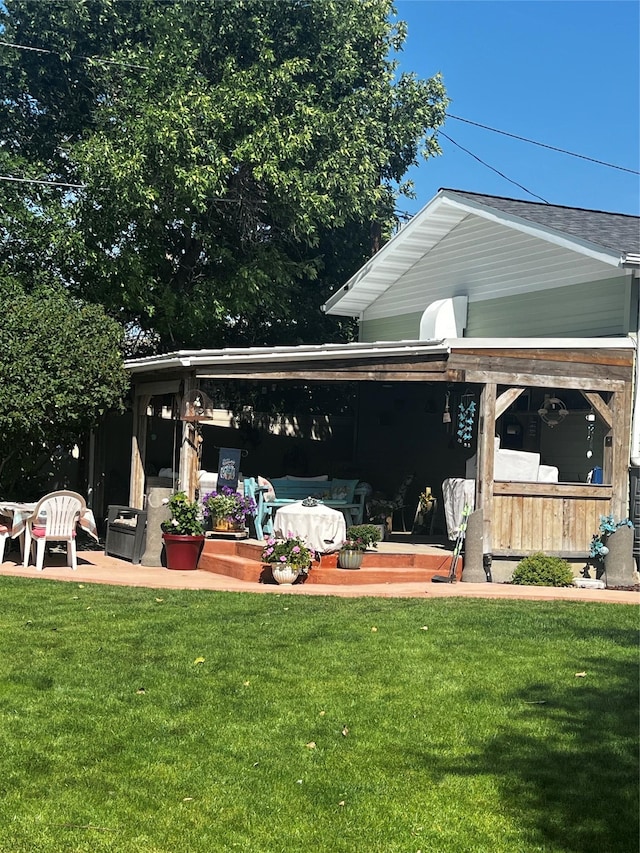 back of house with a patio area and a yard