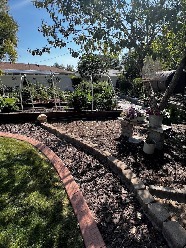 view of yard featuring fence and a garden