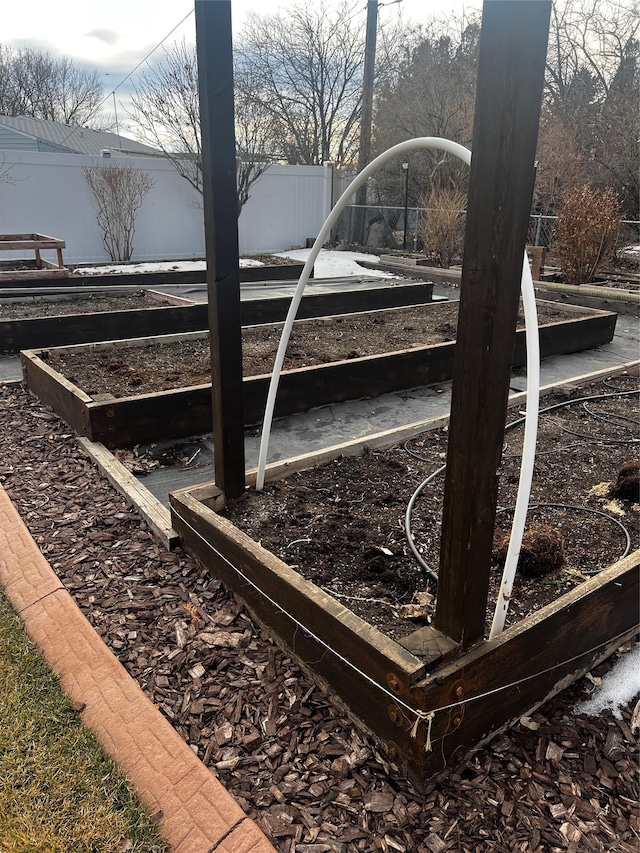 view of yard featuring a vegetable garden and fence