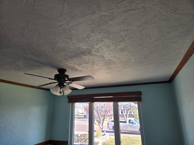 room details with ornamental molding, a textured wall, a textured ceiling, and ceiling fan