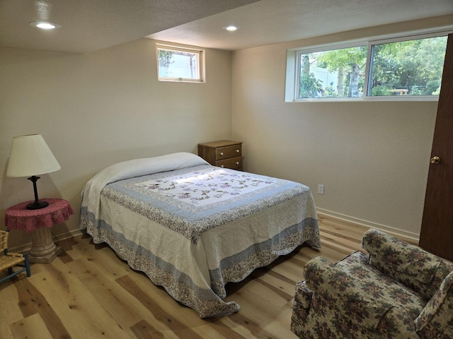 bedroom featuring recessed lighting, light wood-style flooring, and baseboards