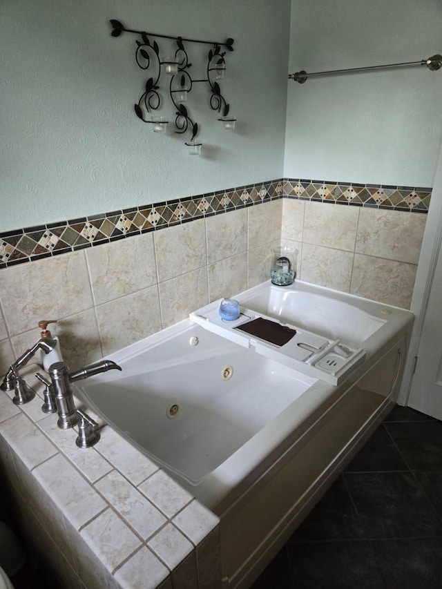 full bath with a tub with jets and tile patterned flooring