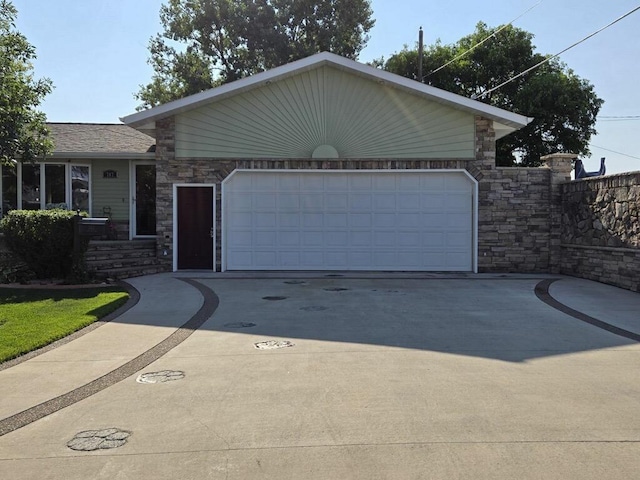 ranch-style home featuring a garage and concrete driveway