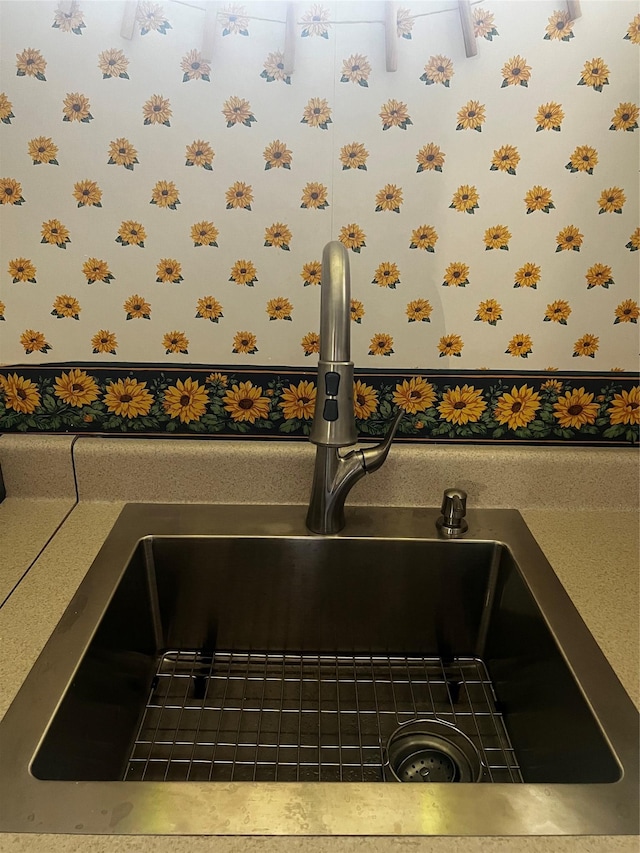 details featuring wallpapered walls and a sink