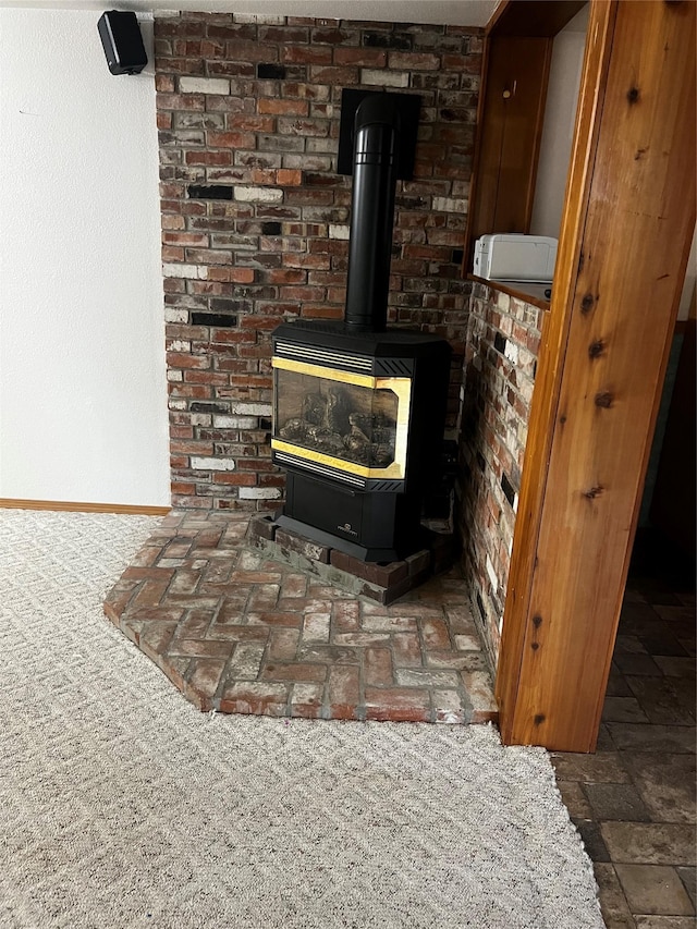 interior details with a wood stove and baseboards