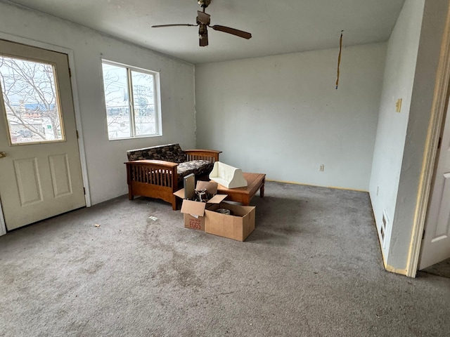 interior space featuring carpet floors and ceiling fan