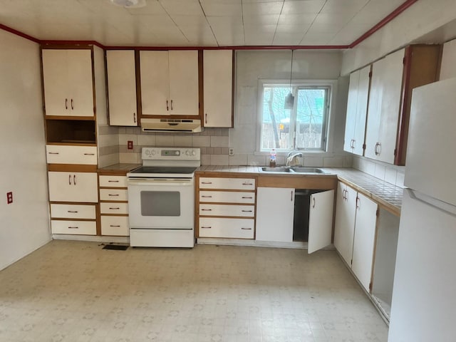 kitchen with white cabinets, white appliances, sink, and tasteful backsplash