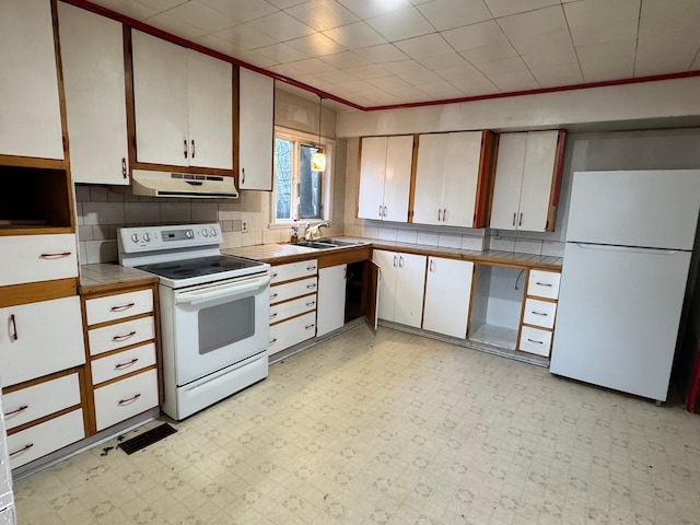 kitchen with sink, white cabinets, white appliances, and ornamental molding