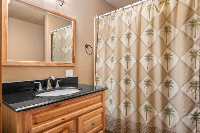 bathroom featuring vanity and curtained shower