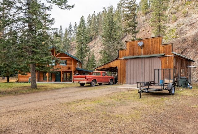 exterior space with a carport and an outbuilding