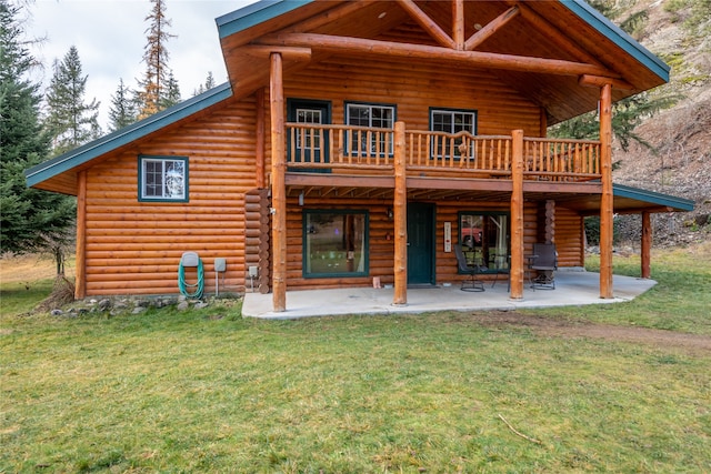 back of house with a patio area, a yard, and a wooden deck