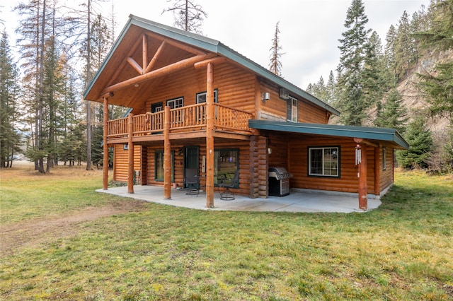 rear view of property featuring a patio area, a yard, and a deck