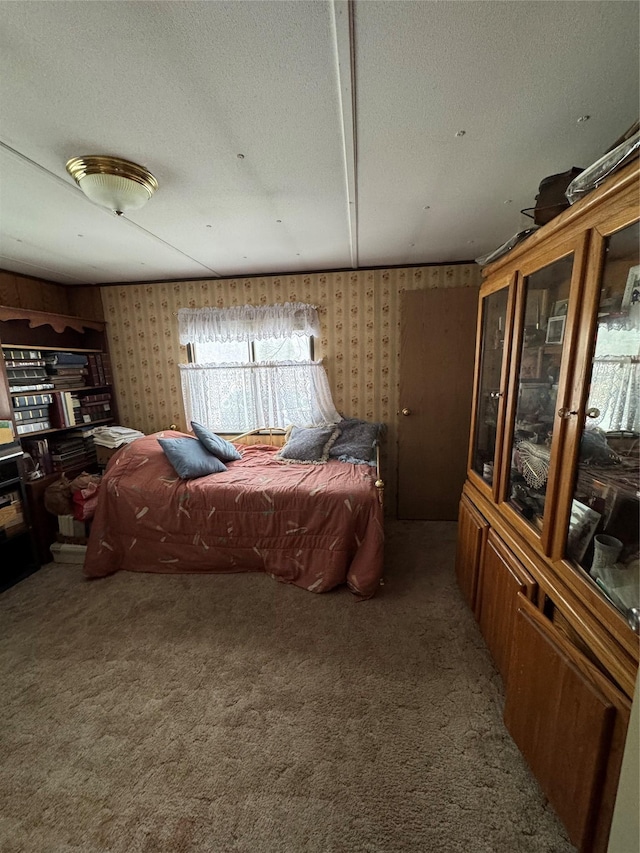 carpeted bedroom featuring a textured ceiling