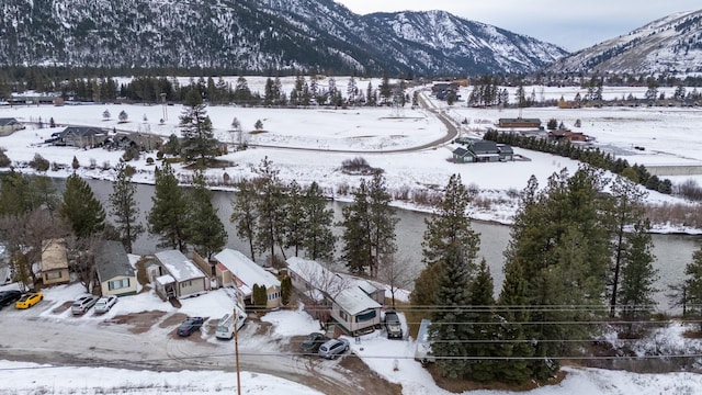 snowy aerial view with a mountain view