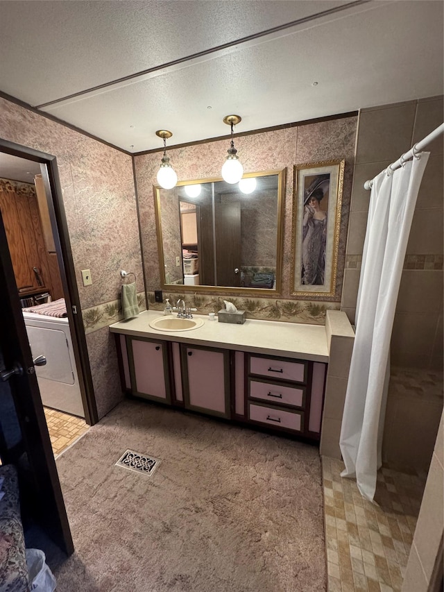 bathroom with vanity, a shower with curtain, crown molding, separate washer and dryer, and a textured ceiling