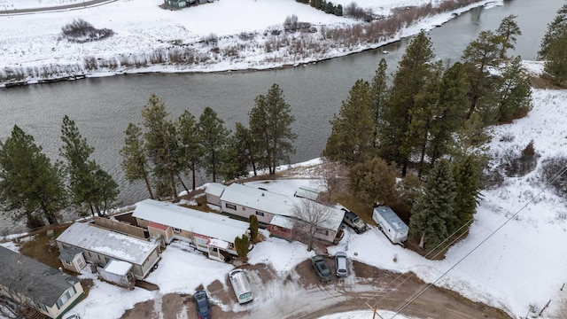 snowy aerial view featuring a water view