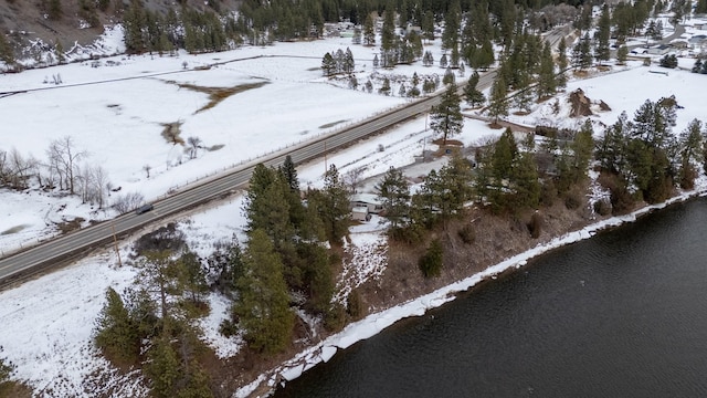 snowy aerial view featuring a water view