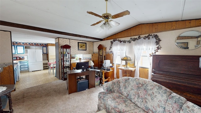 carpeted office space with vaulted ceiling, a wealth of natural light, and a ceiling fan