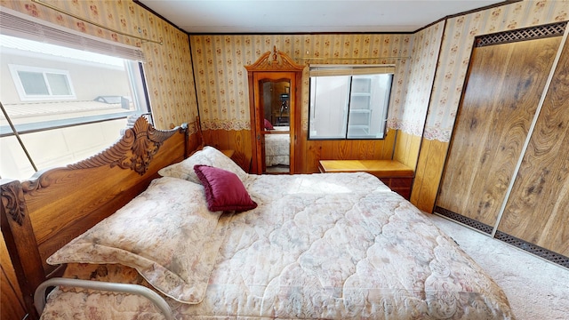 bedroom featuring ornamental molding, carpet floors, and wallpapered walls