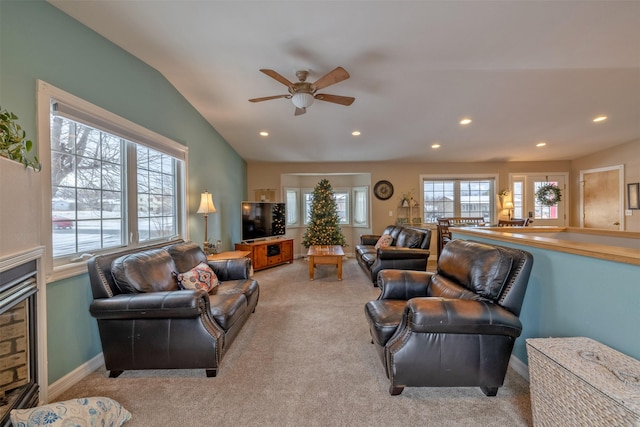 living room featuring ceiling fan, light colored carpet, and vaulted ceiling