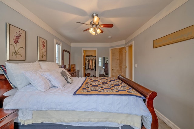 bedroom featuring ceiling fan, a walk in closet, and a closet