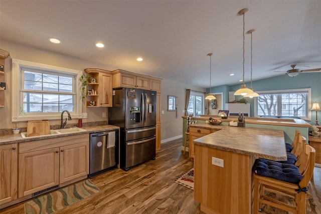 kitchen with ceiling fan, light brown cabinets, hanging light fixtures, dark hardwood / wood-style floors, and appliances with stainless steel finishes