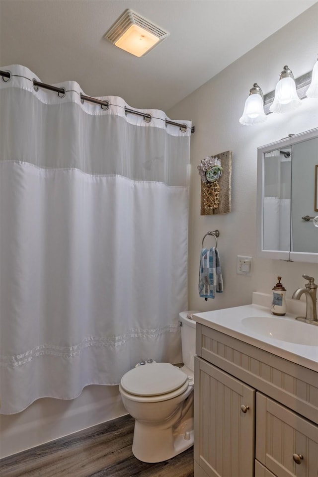 full bathroom featuring wood-type flooring, vanity, toilet, and shower / bath combo with shower curtain