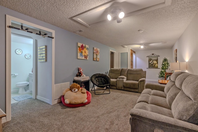 living room featuring light colored carpet and a textured ceiling