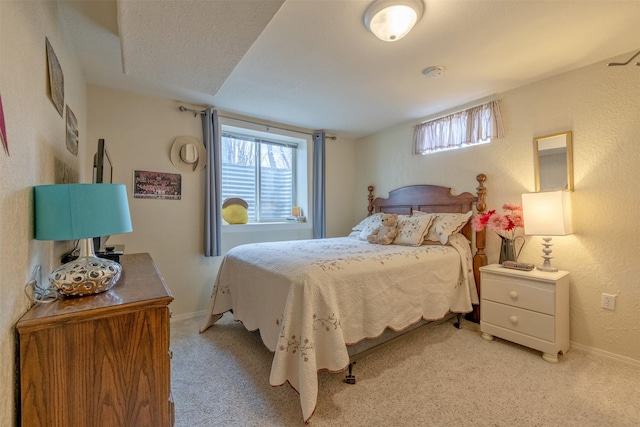 bedroom featuring light colored carpet and multiple windows