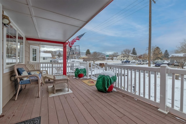 snow covered deck with a porch