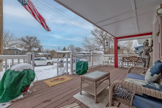 snow covered deck featuring area for grilling