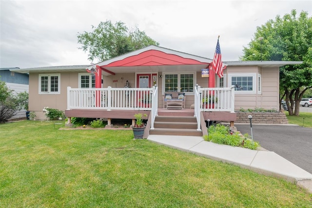 ranch-style house with a front yard and a porch