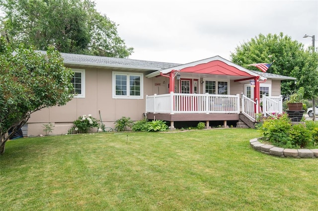 back of property with a deck and a lawn