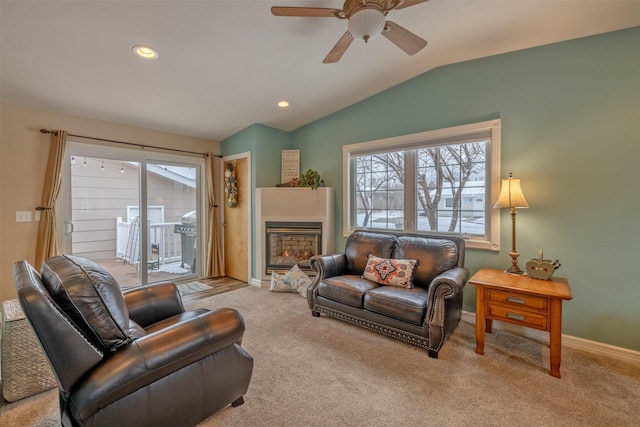 carpeted living room featuring ceiling fan and lofted ceiling