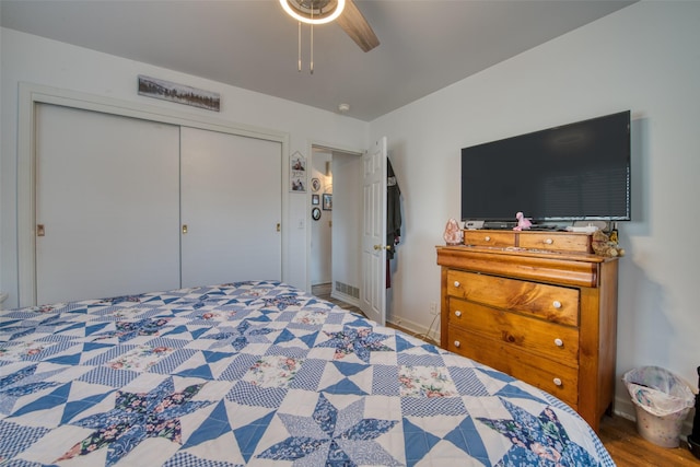 bedroom featuring hardwood / wood-style flooring, ceiling fan, and a closet