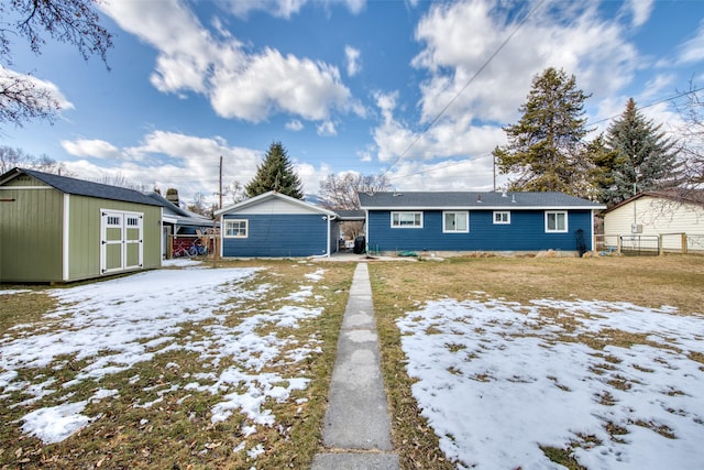 view of front of home featuring a storage shed