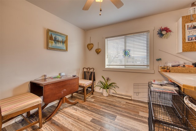 office space with ceiling fan, wood-type flooring, and baseboard heating