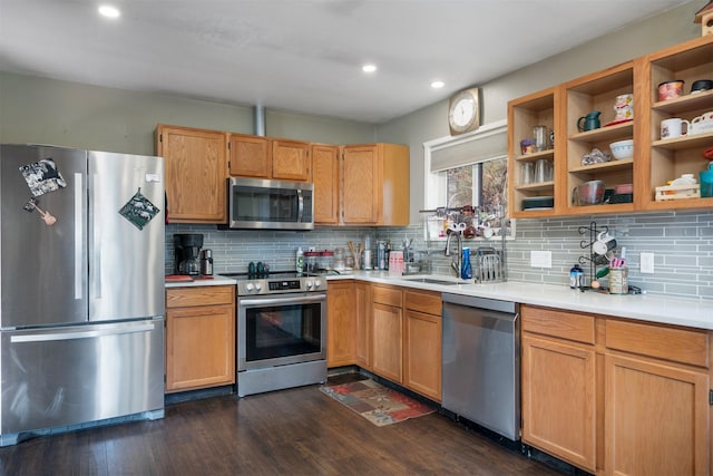 kitchen with tasteful backsplash, sink, appliances with stainless steel finishes, and dark wood-type flooring