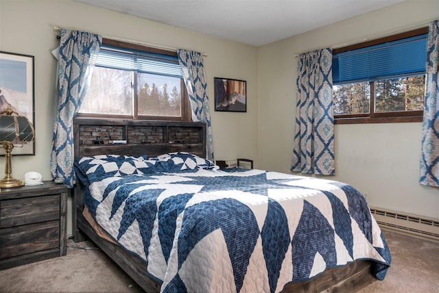 bedroom featuring baseboard heating and light carpet