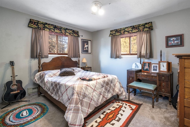 carpeted bedroom with a baseboard radiator