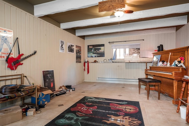 misc room featuring beam ceiling, ceiling fan, wooden walls, and light tile patterned flooring