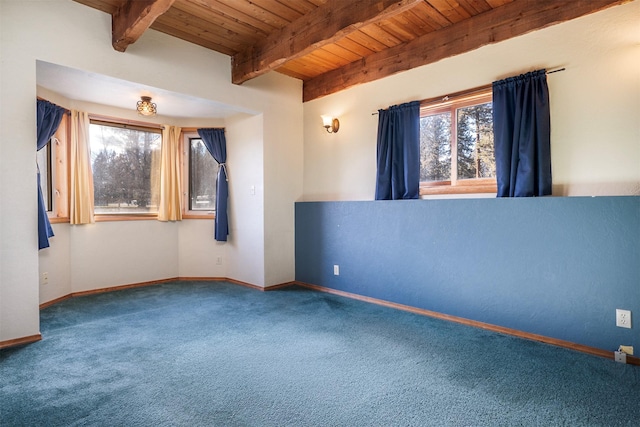 carpeted empty room featuring beamed ceiling and wood ceiling