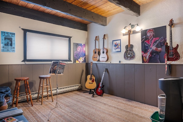 interior space featuring light carpet, beam ceiling, a baseboard radiator, wooden ceiling, and wood walls