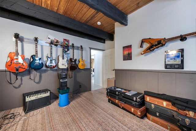 interior space featuring carpet, beam ceiling, and wood ceiling