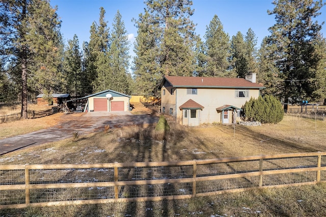 view of front of property with an outbuilding and a garage