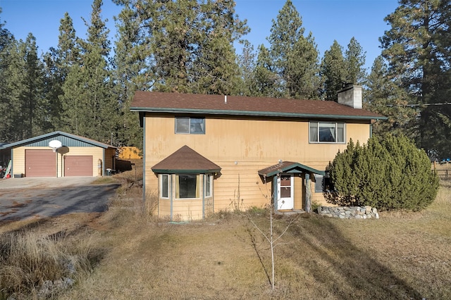 view of front facade with an outbuilding and a garage