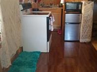 kitchen with dark hardwood / wood-style floors, white stove, and stainless steel refrigerator